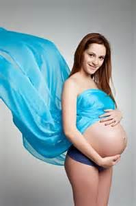  Women showing her sign of being pregnant having used holistic fertility treatment outline in the eBook