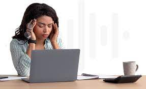 EMF can cause a number of symptoms depicting a woman on a laptop show signs of fatigue and brain fog needing the best EMF Protection with TUUN 