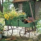Garden decor with wagon planter for outdoor landscape decor colored in rich green.